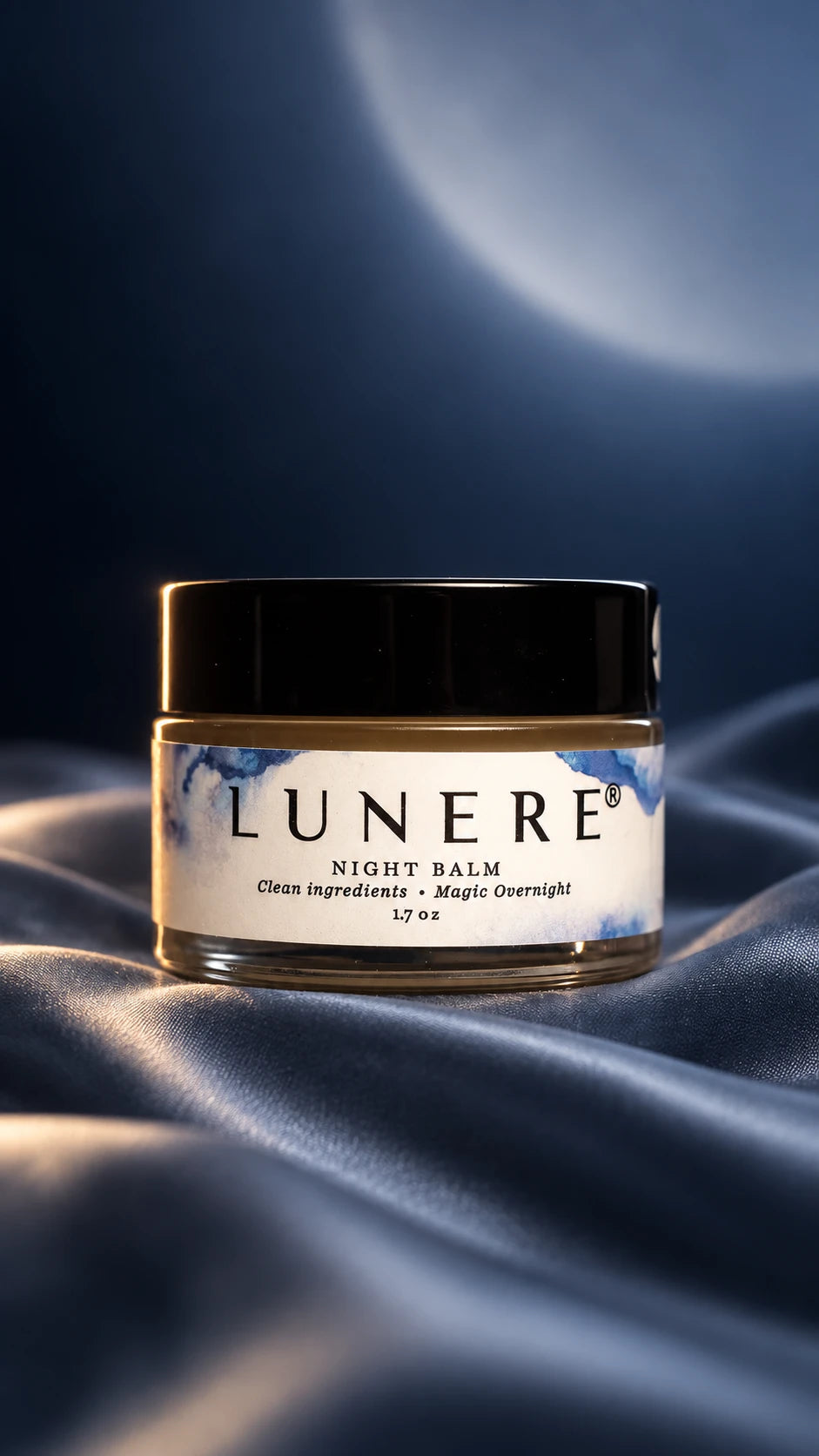Lunere Night Balm on blue silk in soft evening light